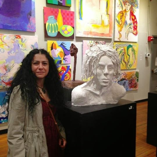 With a portrait sculpture at a group exhibition