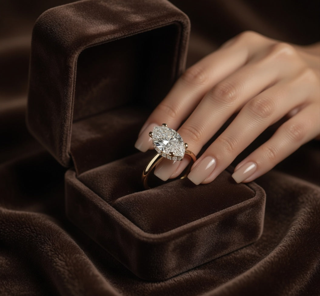 2ct Marquise Cut Hidden Halo Lab Grown Diamond Engagement Ring on a hand with a brown velvet box