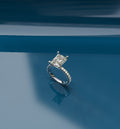 4ct Radiant Cut Micro Pavé Lab Grown Diamond Engagement Ring on a reflective blue surface