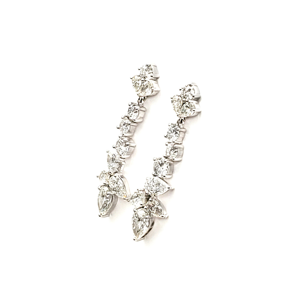 Pear and round diamond dangle earrings angled view