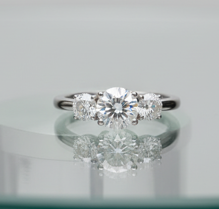 Classic Basket Three Stone Diamond Engagement Ring flat lay